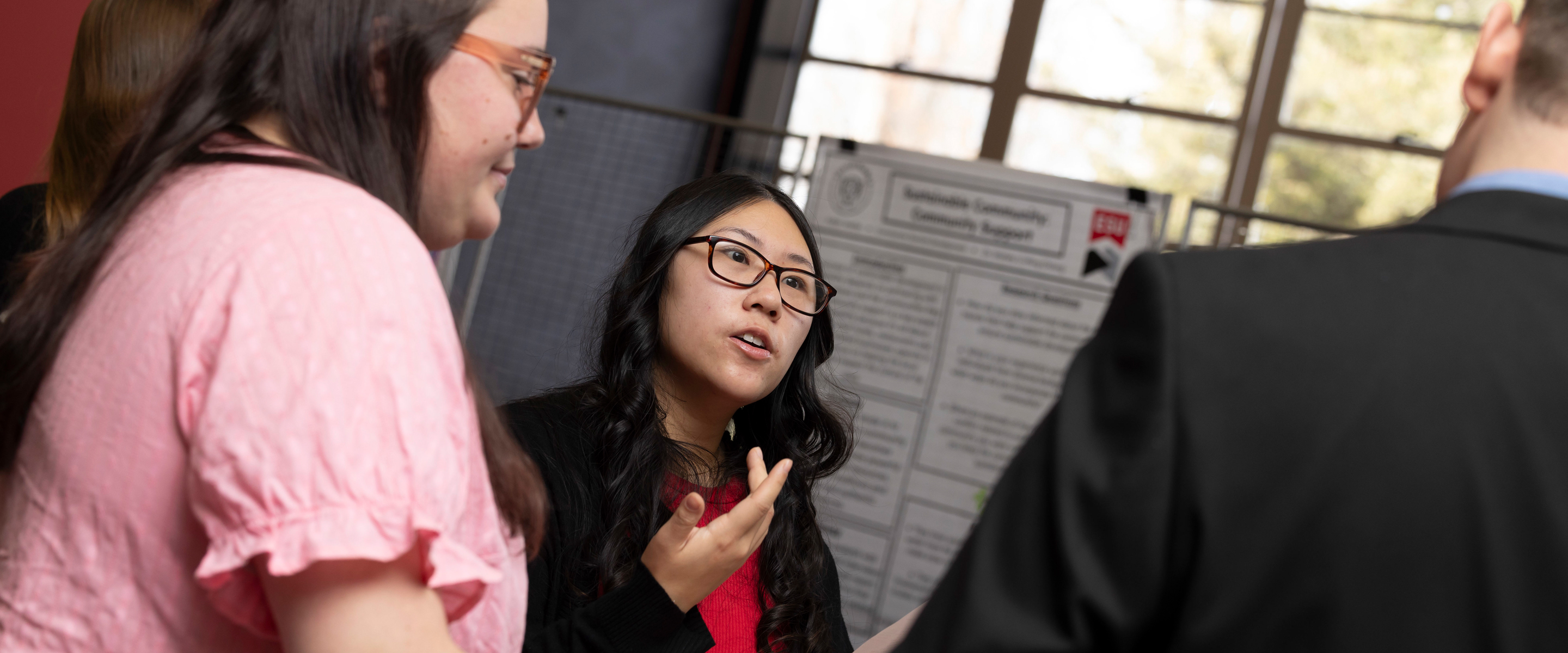 Faculty member and student talking