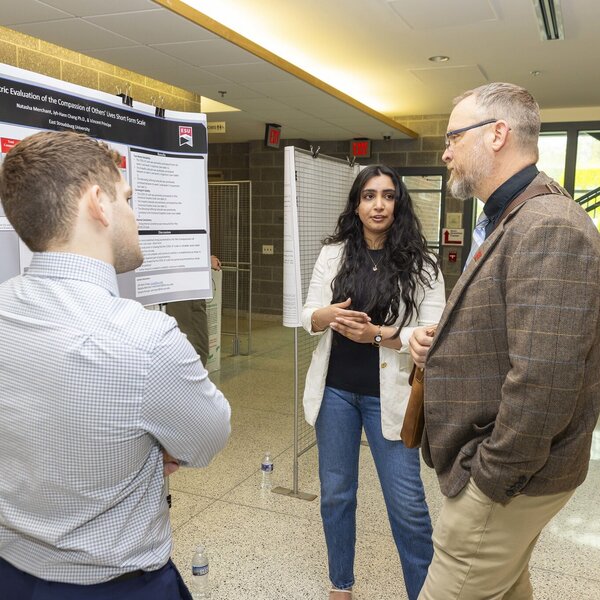 Student presenting to a professor