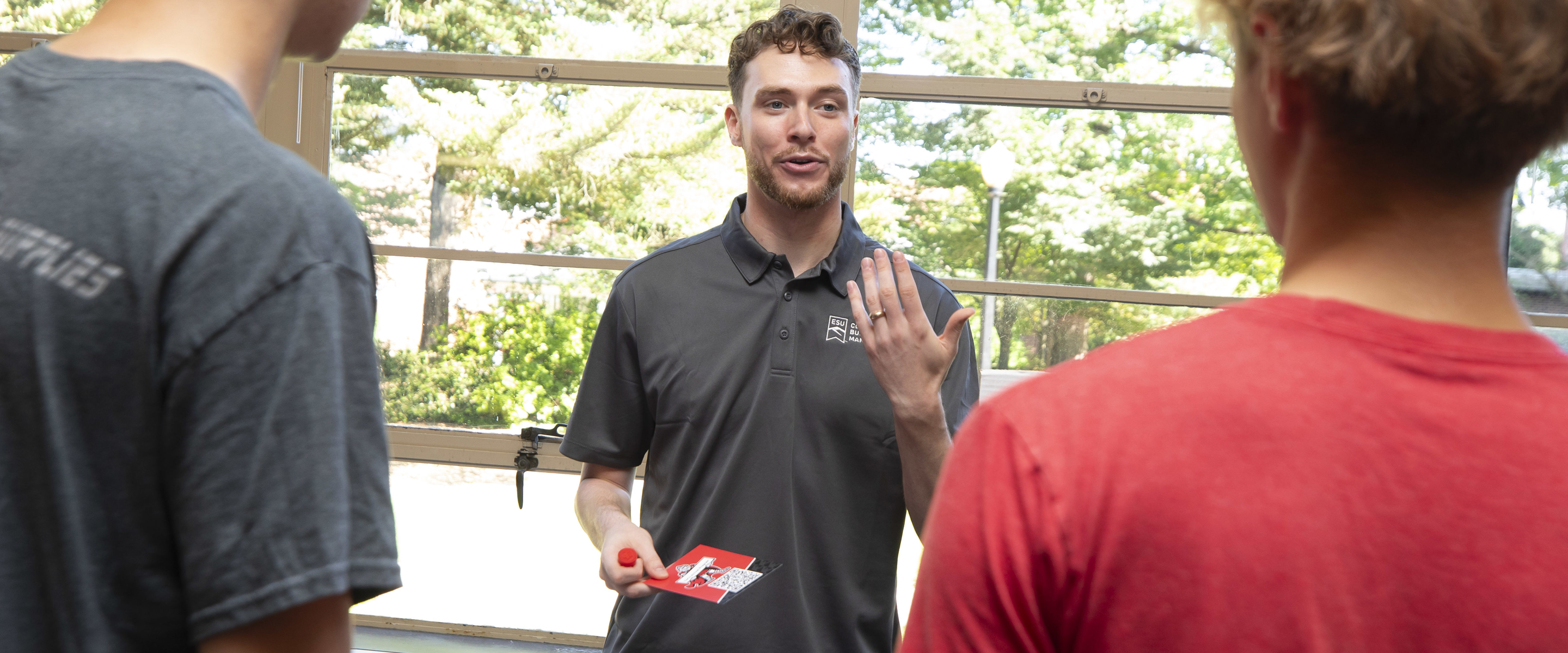 Student success coach talking to students