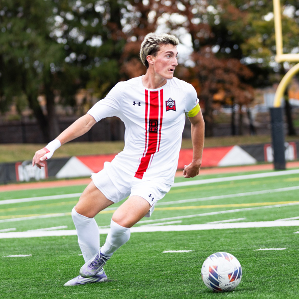 Male soccer player kicking a ball