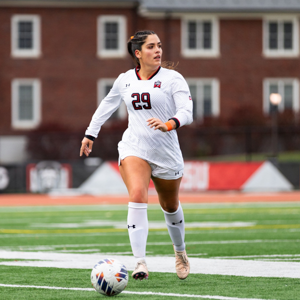 Female soccer player kicking the ball