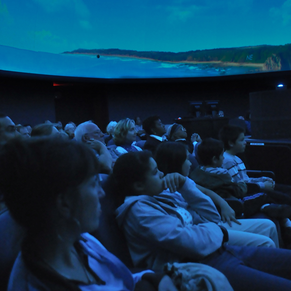 Students sitting in teh planetarium